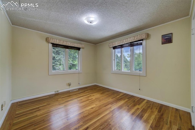 130 Cresta Rd, Colorado Springs, CO 80906 - unfurnished room with crown molding, a textured ceiling, wood finished floors, plenty of natural light, and baseboards