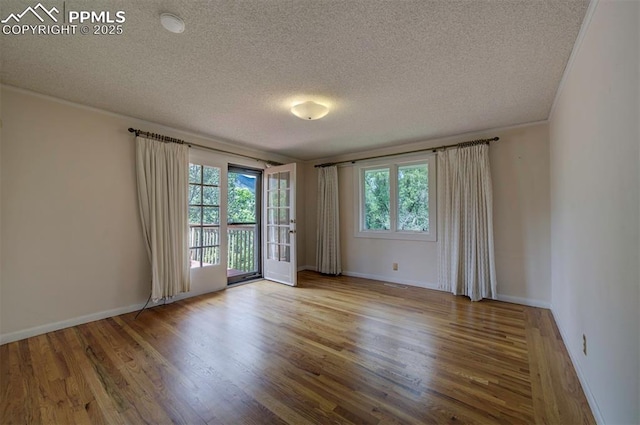130 Cresta Rd, Colorado Springs, CO 80906 - spare room featuring wood finished floors, a textured ceiling, and baseboards