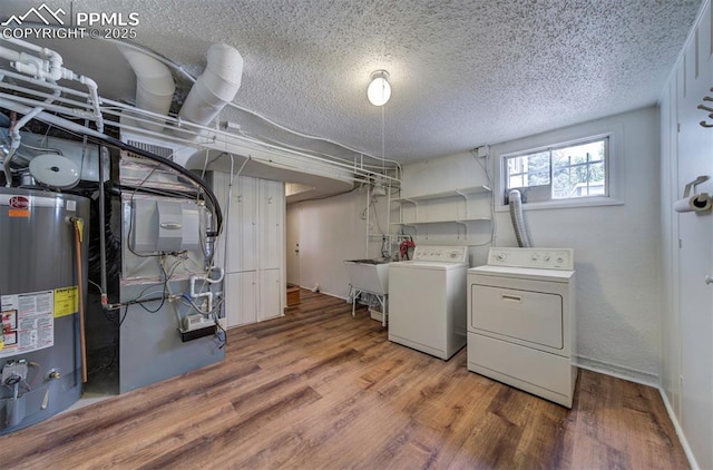 130 Cresta Rd, Colorado Springs, CO 80906 - laundry room with washing machine and dryer, water heater, a textured ceiling, wood finished floors, and heating unit