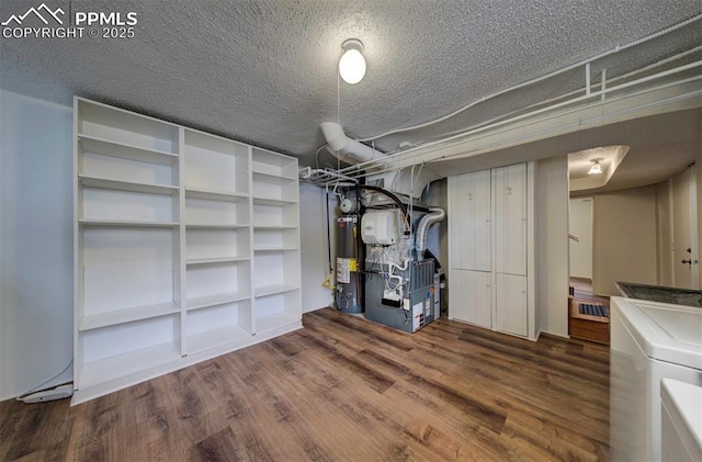 130 Cresta Rd, Colorado Springs, CO 80906 - finished below grade area with water heater, wood finished floors, washer / clothes dryer, a textured ceiling, and heating unit