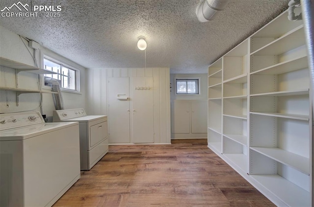 130 Cresta Rd, Colorado Springs, CO 80906 - washroom featuring separate washer and dryer, a textured ceiling, wood finished floors, and plenty of natural light