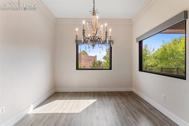 24 Redondo Ln, Pueblo, CO 81005 - spare room featuring a chandelier, wood finished floors, ornamental molding, and baseboards