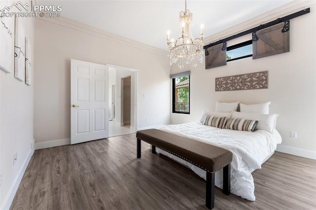 24 Redondo Ln, Pueblo, CO 81005 - bedroom featuring a chandelier, wood finished floors, baseboards, and ornamental molding