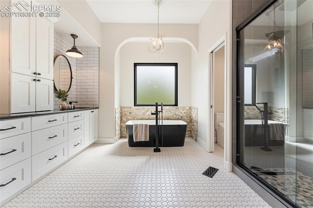 24 Redondo Ln, Pueblo, CO 81005 - full bath with vanity, a stall shower, a freestanding bath, and toilet