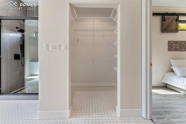 24 Redondo Ln, Pueblo, CO 81005 - bathroom with a shower stall, a spacious closet, and baseboards