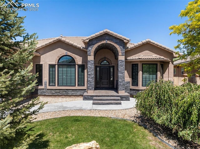 24 Redondo Ln, Pueblo, CO 81005 - view of front of property with a tiled roof, stucco siding, and stone siding