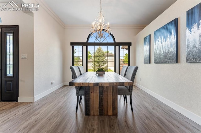 24 Redondo Ln, Pueblo, CO 81005 - dining space featuring a chandelier, wood finished floors, baseboards, a textured wall, and crown molding