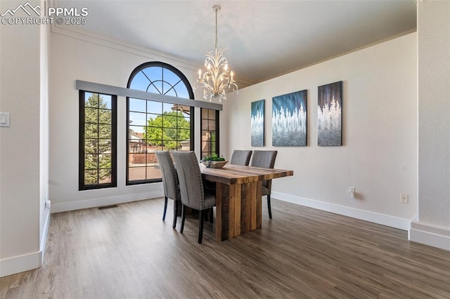 24 Redondo Ln, Pueblo, CO 81005 - dining area with a chandelier, wood finished floors, baseboards, and ornamental molding