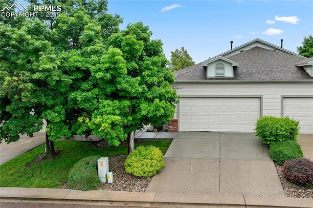 1020 Samuel Pt, Colorado Springs, CO 80906 - view of front of home with a shingled roof, concrete driveway, and an attached garage