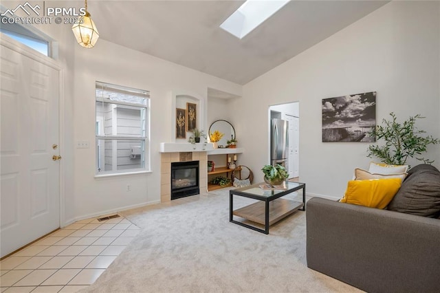 1020 Samuel Pt, Colorado Springs, CO 80906 - living room with lofted ceiling, a skylight, a fireplace, light carpet, and baseboards