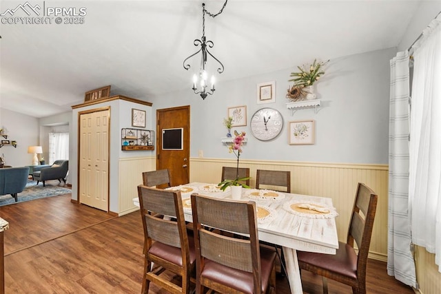 6150 Fall River Dr, Colorado Springs, CO 80918 - dining area featuring a chandelier, wainscoting, and wood finished floors