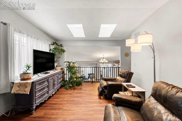 6150 Fall River Dr, Colorado Springs, CO 80918 - living area featuring a chandelier, wood finished floors, and a skylight