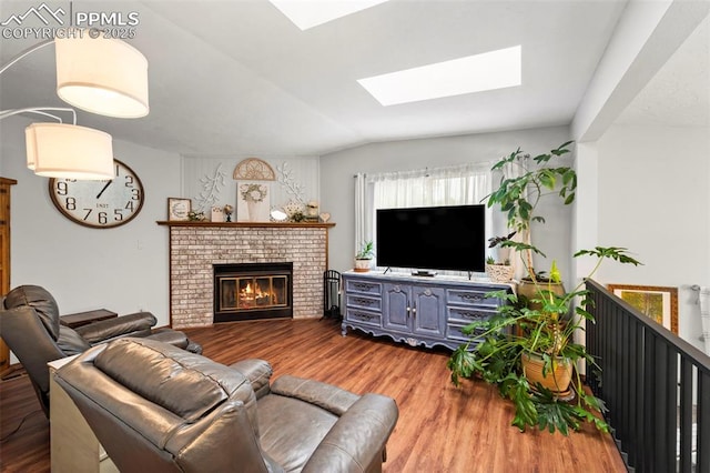 6150 Fall River Dr, Colorado Springs, CO 80918 - living room with a skylight, wood finished floors, a brick fireplace, and vaulted ceiling