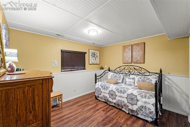6150 Fall River Dr, Colorado Springs, CO 80918 - bedroom featuring a wainscoted wall, wood finished floors, and wood ceiling