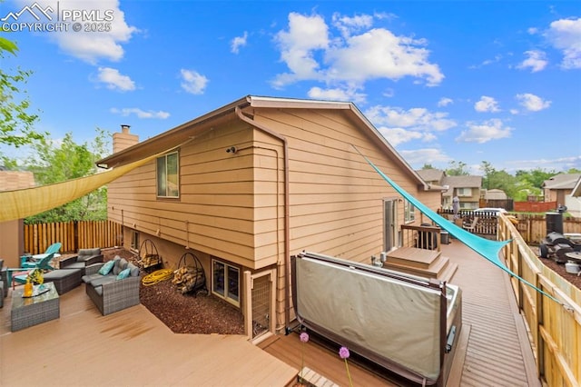 6150 Fall River Dr, Colorado Springs, CO 80918 - back of house with an outdoor living space, a chimney, and a wooden deck