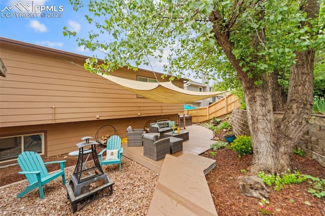 6150 Fall River Dr, Colorado Springs, CO 80918 - view of patio / terrace with an outdoor living space with a fire pit