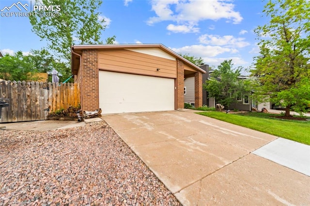 6150 Fall River Dr, Colorado Springs, CO 80918 - view of front of house with brick siding, concrete driveway, and a garage