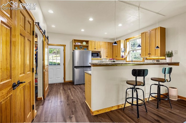 7545 Hollandale Dr, Colorado Springs, CO 80919 - kitchen featuring appliances with stainless steel finishes, a barn door, healthy amount of natural light, dark wood-style floors, and recessed lighting