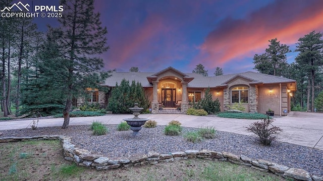 17910 Queensmere Dr, Monument, CO 80132 - ranch-style home featuring stone siding and a tiled roof
