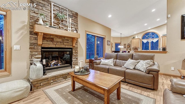 17910 Queensmere Dr, Monument, CO 80132 - living area with wood finished floors, lofted ceiling, a fireplace, recessed lighting, and baseboards