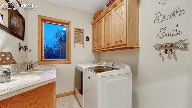17910 Queensmere Dr, Monument, CO 80132 - laundry room with cabinet space, washer and clothes dryer, light tile patterned floors, and baseboards