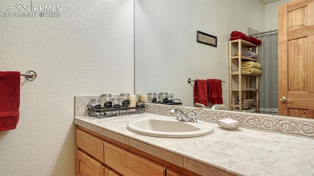 17910 Queensmere Dr, Monument, CO 80132 - bathroom with vanity, a textured wall, and a shower with shower curtain