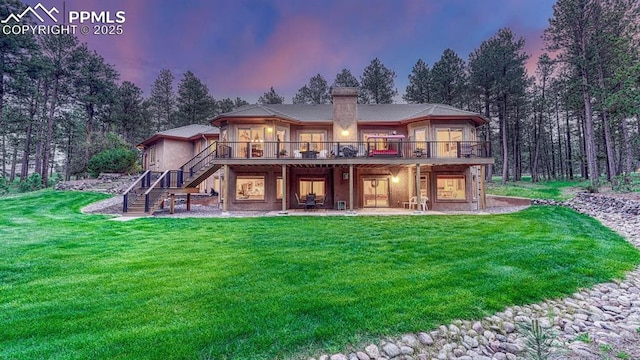 17910 Queensmere Dr, Monument, CO 80132 - back of house with stairs, a wooden deck, a yard, a chimney, and a patio