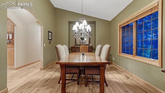 17910 Queensmere Dr, Monument, CO 80132 - dining room featuring arched walkways, light wood-style floors, lofted ceiling, a chandelier, and baseboards
