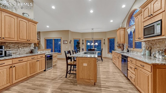 17910 Queensmere Dr, Monument, CO 80132 - kitchen featuring beverage cooler, appliances with stainless steel finishes, a kitchen bar, a center island, and backsplash