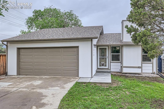610 E San Gabriel Pl, Colorado Springs, CO 80906 - ranch-style home featuring concrete driveway, an attached garage, roof with shingles, and a front yard