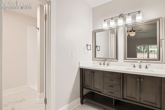 610 E San Gabriel Pl, Colorado Springs, CO 80906 - bathroom featuring marble finish flooring, a ceiling fan, double vanity, and baseboards