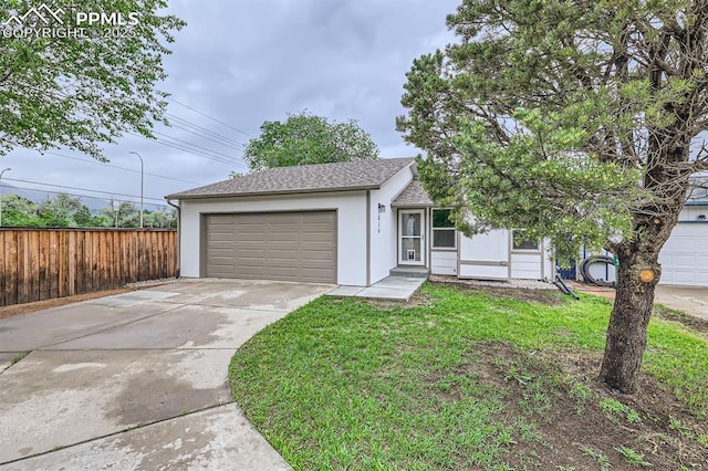 610 E San Gabriel Pl, Colorado Springs, CO 80906 - ranch-style house with driveway, an attached garage, a shingled roof, and stucco siding