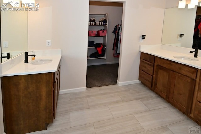 1213 E Tidy Dr, Pueblo, CO 81007 - full bath with a spacious closet, two vanities, and baseboards