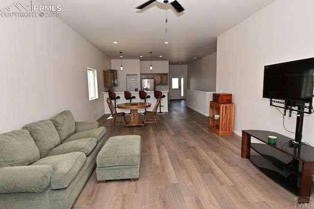 1213 E Tidy Dr, Pueblo, CO 81007 - living room with ceiling fan, wood finished floors, baseboards, and recessed lighting