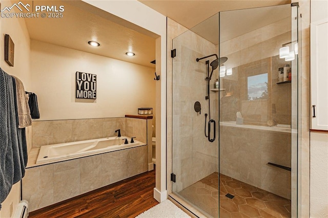 5145 Golden Hills Ct, Colorado Springs, CO 80919 - full bathroom with a bath, wood finished floors, a shower stall, and baseboard heating