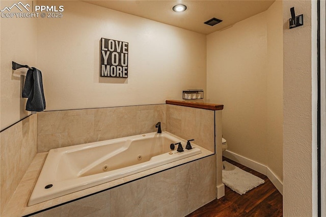 5145 Golden Hills Ct, Colorado Springs, CO 80919 - bathroom with toilet, wood finished floors, a jetted tub, and baseboards