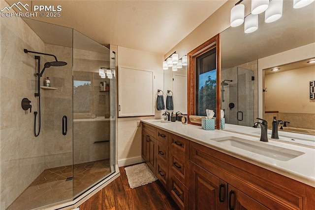 5145 Golden Hills Ct, Colorado Springs, CO 80919 - bathroom with wood finished floors, a stall shower, and double vanity
