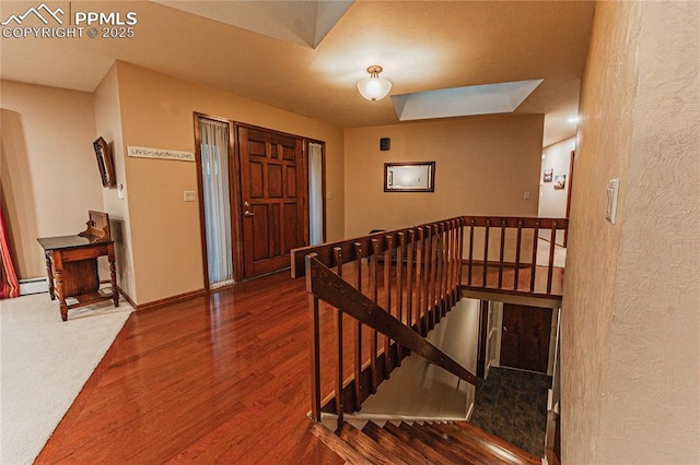 5145 Golden Hills Ct, Colorado Springs, CO 80919 - foyer featuring wood finished floors, a textured wall, a baseboard heating unit, and baseboards