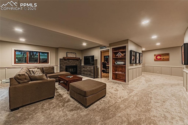 5145 Golden Hills Ct, Colorado Springs, CO 80919 - carpeted living area featuring recessed lighting, a decorative wall, bar area, baseboard heating, and a stone fireplace