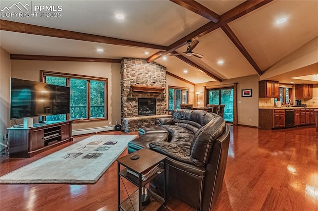 5145 Golden Hills Ct, Colorado Springs, CO 80919 - living room featuring baseboard heating, a ceiling fan, a fireplace, dark wood-style flooring, and recessed lighting