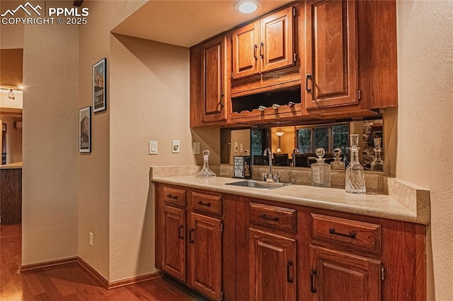 5145 Golden Hills Ct, Colorado Springs, CO 80919 - bar area with a sink, dark wood-style flooring, a textured wall, and baseboards
