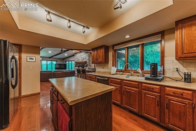 5145 Golden Hills Ct, Colorado Springs, CO 80919 - kitchen with a sink, fridge with ice dispenser, stainless steel dishwasher, decorative backsplash, and a ceiling fan