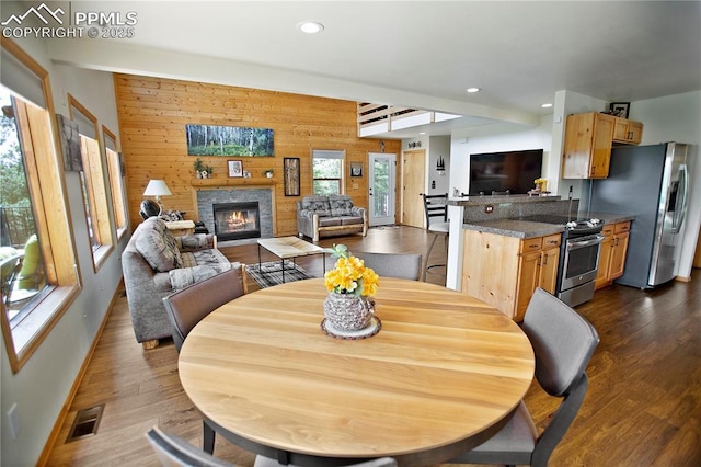 409 Pike View Dr, Divide, CO 80814 - dining room with wooden walls, baseboards, a glass covered fireplace, recessed lighting, and dark wood finished floors