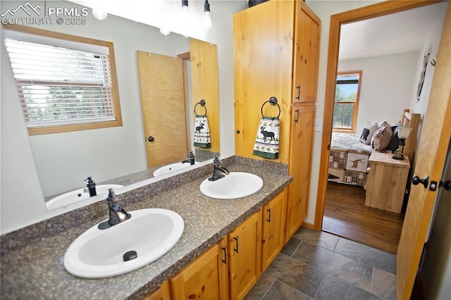 409 Pike View Dr, Divide, CO 80814 - full bath featuring double vanity, connected bathroom, and stone tile flooring