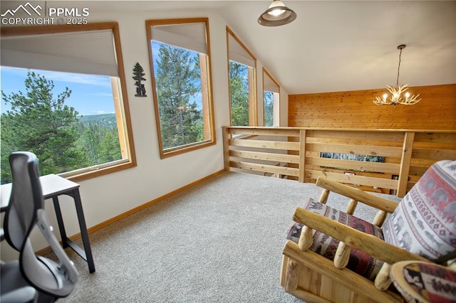 409 Pike View Dr, Divide, CO 80814 - sitting room with carpet floors, vaulted ceiling, baseboards, a chandelier, and wooden walls