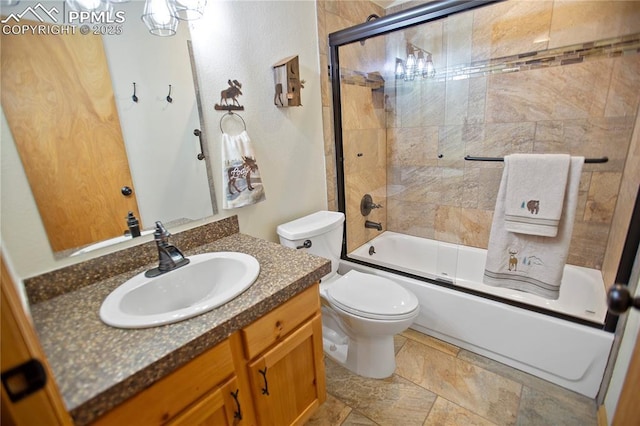 409 Pike View Dr, Divide, CO 80814 - full bathroom featuring toilet, vanity, shower / bath combination with glass door, and stone finish floors
