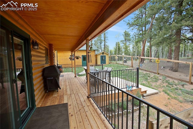 409 Pike View Dr, Divide, CO 80814 - wooden terrace with a grill, a fenced backyard, and outdoor dining space
