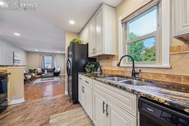 107 N Logan Ave, Colorado Springs, CO 80909 - kitchen with black appliances, a sink, dark stone counters, white cabinetry, and backsplash