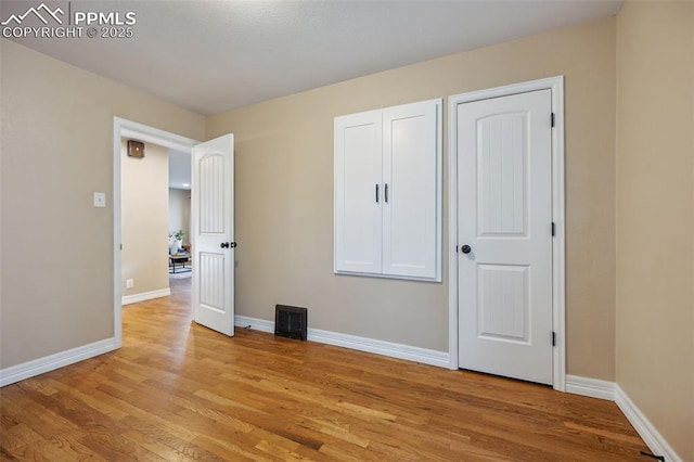 107 N Logan Ave, Colorado Springs, CO 80909 - unfurnished bedroom with light wood-style floors and baseboards