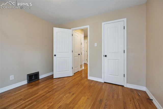 107 N Logan Ave, Colorado Springs, CO 80909 - unfurnished bedroom with baseboards and wood finished floors